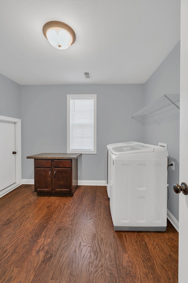 washroom with independent washer and dryer and dark hardwood / wood-style floors