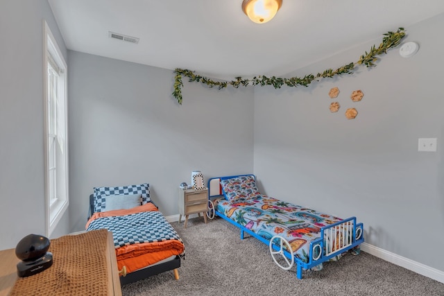 bedroom with multiple windows and carpet flooring