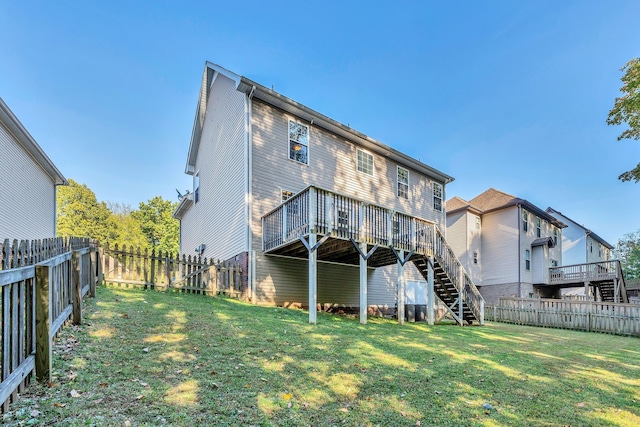 rear view of property featuring a deck and a yard