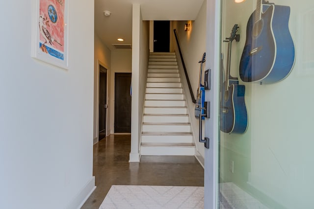 staircase with concrete floors