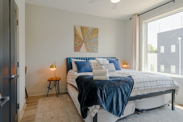 bedroom with light wood-type flooring and ceiling fan