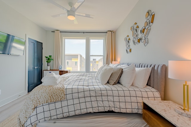 bedroom featuring light hardwood / wood-style floors and ceiling fan