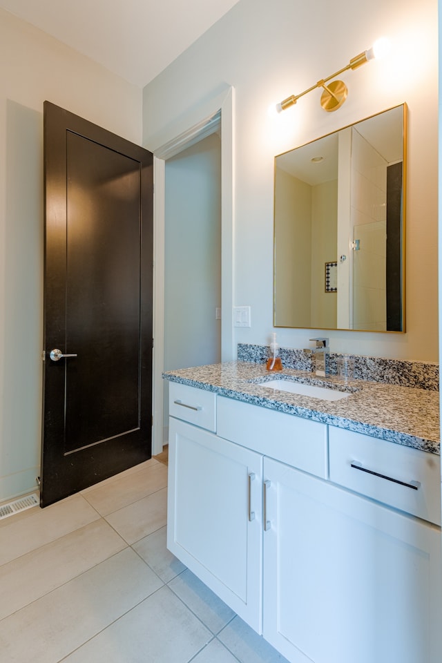 bathroom with vanity and tile patterned flooring