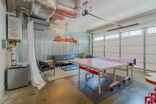 recreation room featuring a healthy amount of sunlight and concrete flooring