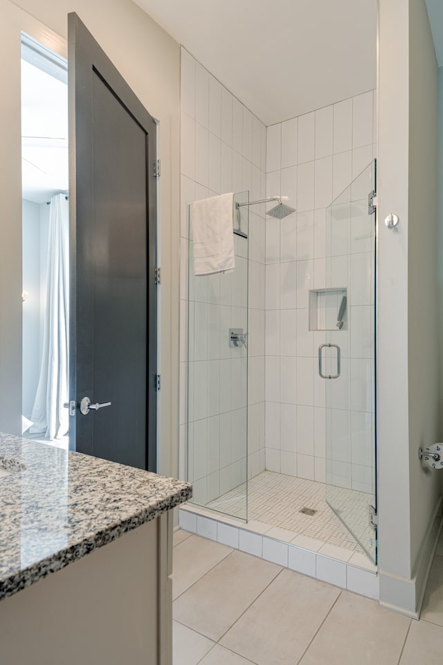 bathroom with vanity, tile patterned floors, and an enclosed shower