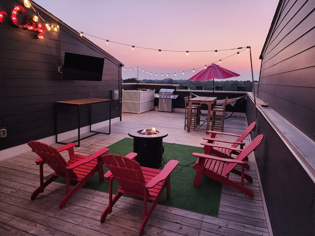 wooden deck with a fire pit