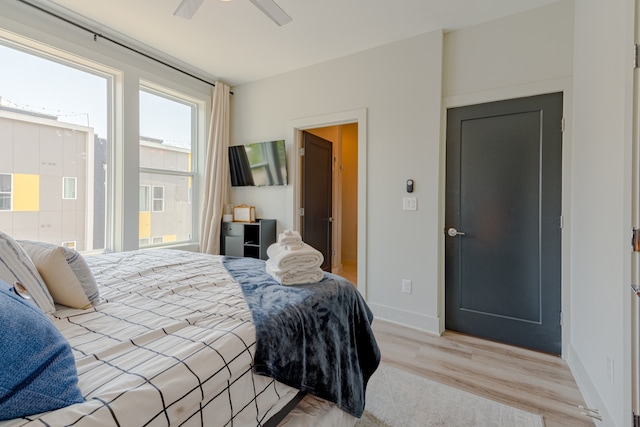 bedroom with ceiling fan and light hardwood / wood-style flooring