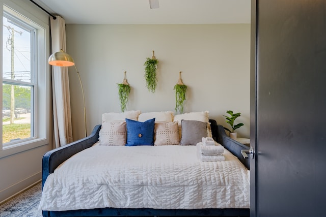 bedroom featuring multiple windows and ceiling fan