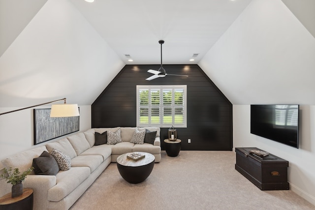 living room with lofted ceiling, ceiling fan, and light carpet