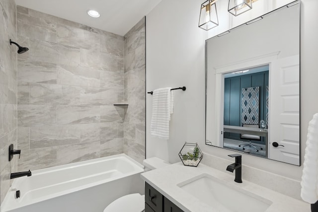 full bathroom featuring toilet, vanity, and tiled shower / bath combo