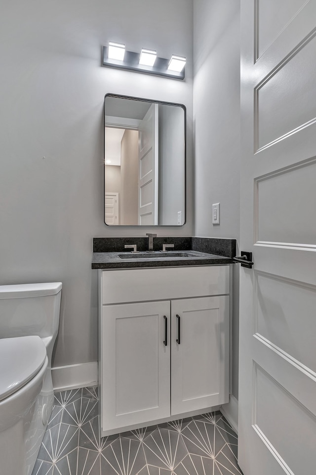 bathroom featuring vanity, toilet, and tile patterned floors