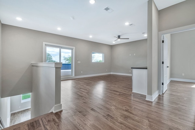 unfurnished living room with hardwood / wood-style flooring and ceiling fan