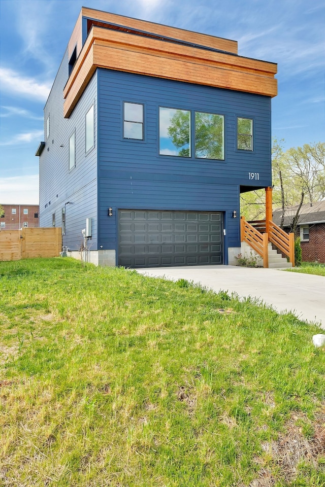 contemporary home with a garage and a front lawn