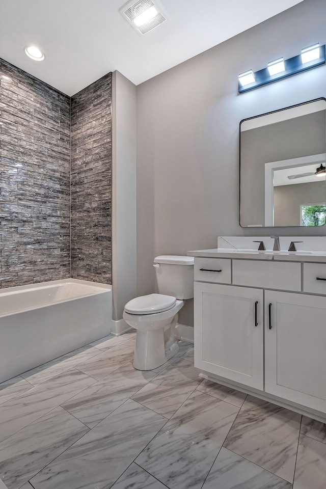 bathroom with vanity, toilet, and ceiling fan