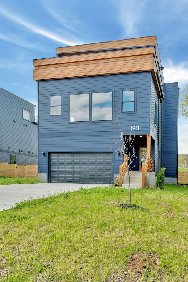 view of front of property featuring a front lawn and a garage