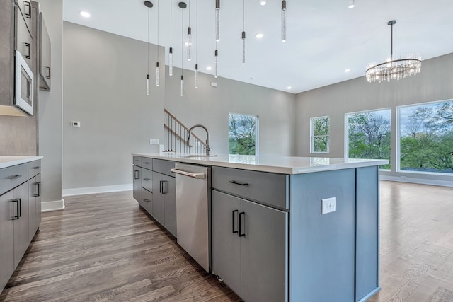 kitchen with gray cabinetry, a center island, and pendant lighting