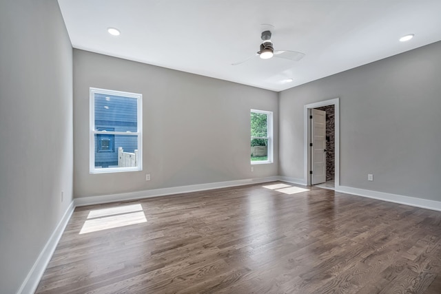 empty room with dark wood-type flooring and ceiling fan