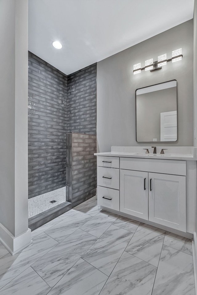 bathroom with vanity and tiled shower