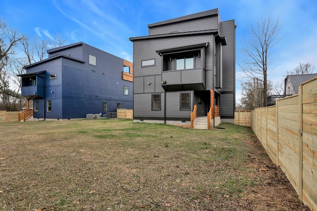 back of property with a lawn and central AC unit