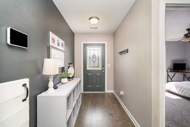 foyer entrance with dark hardwood / wood-style floors and ceiling fan