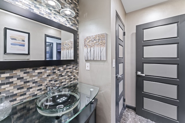 bathroom featuring tasteful backsplash and vanity