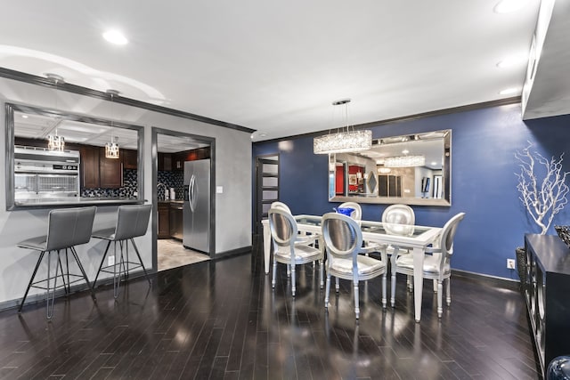 dining room featuring hardwood / wood-style flooring and ornamental molding