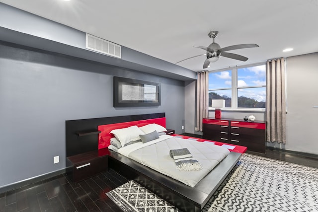 bedroom with ceiling fan and dark wood-type flooring