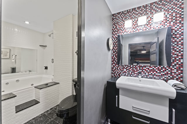 bathroom with a bath, vanity, tasteful backsplash, and toilet