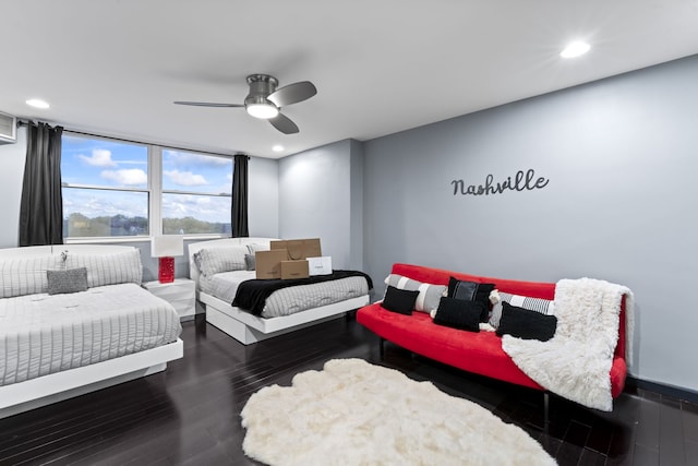 bedroom with ceiling fan and dark wood-type flooring