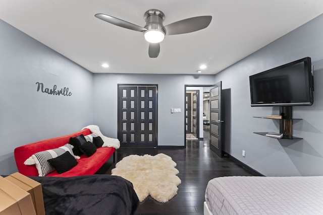 bedroom with ceiling fan and dark hardwood / wood-style flooring