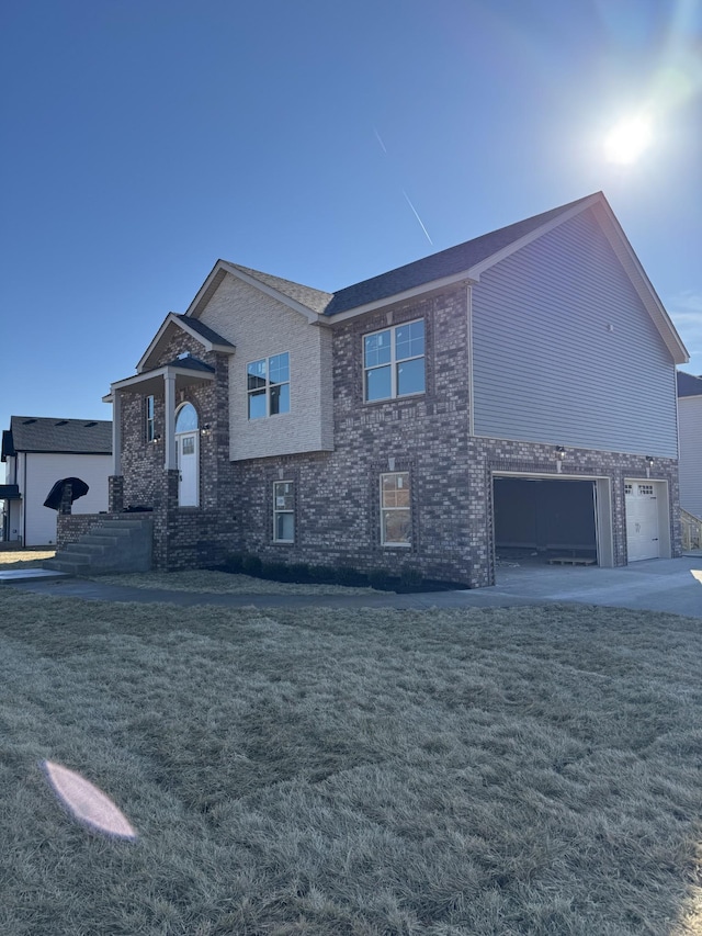 view of front of house featuring a garage and a front lawn