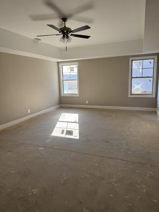 spare room featuring concrete floors and ceiling fan