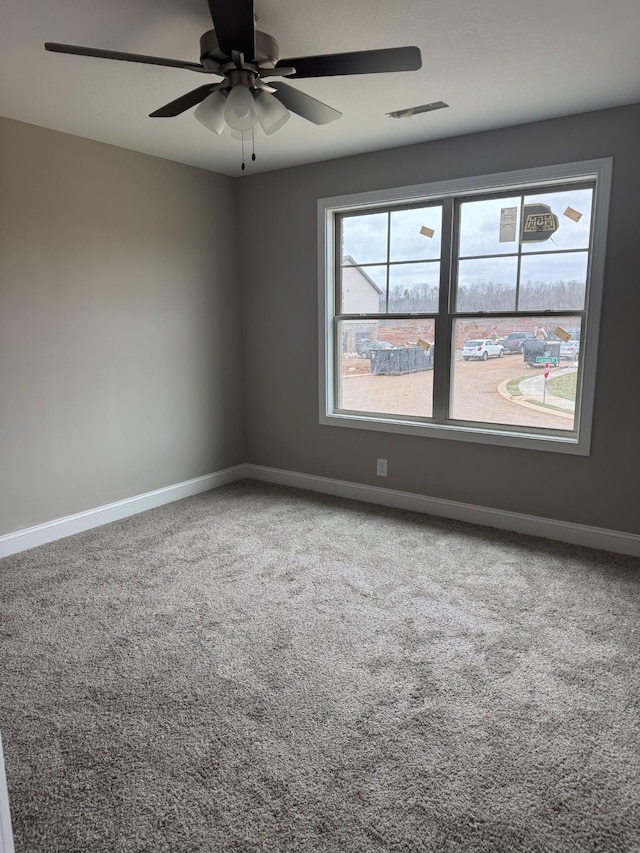 carpeted empty room with ceiling fan