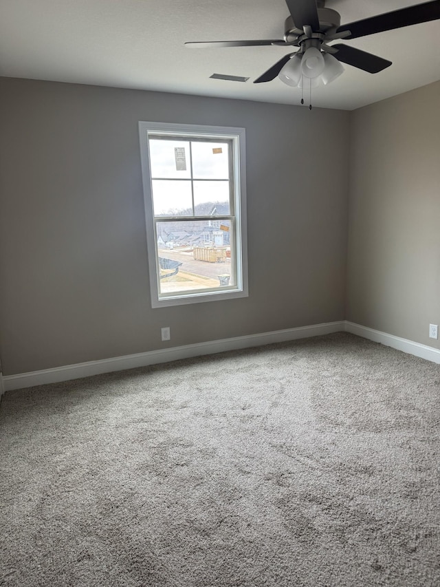 carpeted empty room featuring ceiling fan