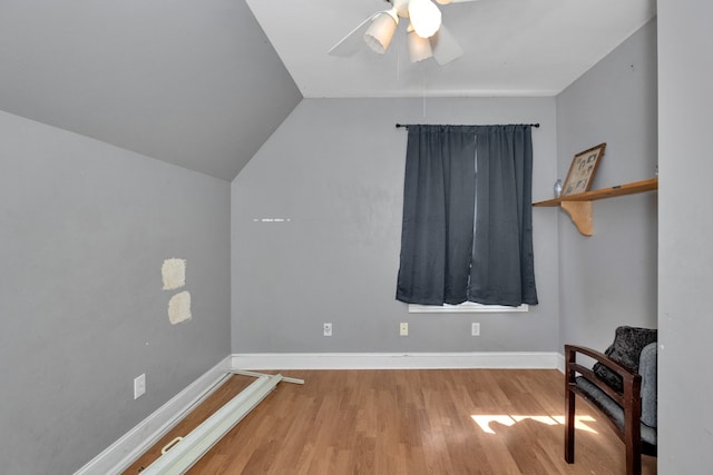 interior space featuring ceiling fan, lofted ceiling, and light hardwood / wood-style flooring