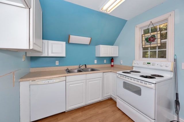 kitchen with white appliances, vaulted ceiling, white cabinetry, and sink