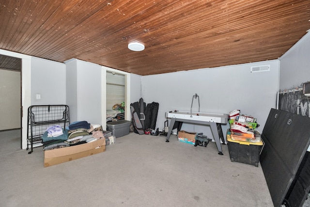 interior space featuring light colored carpet and wooden ceiling