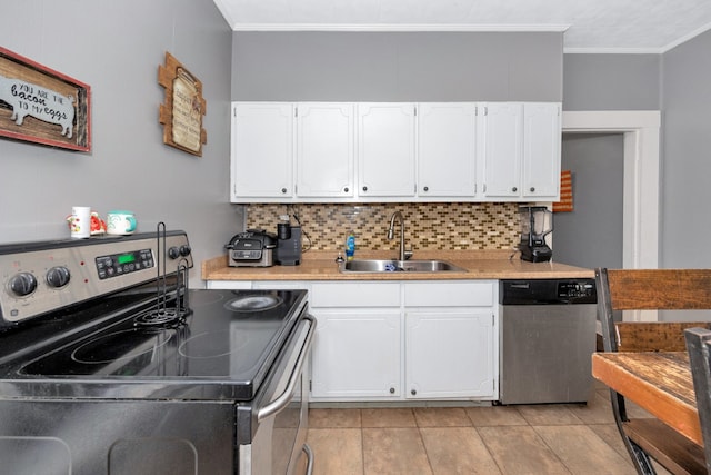 kitchen with decorative backsplash, stainless steel appliances, ornamental molding, sink, and white cabinetry