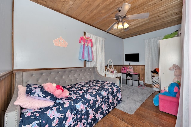 bedroom featuring wooden walls, wood ceiling, hardwood / wood-style flooring, and ceiling fan