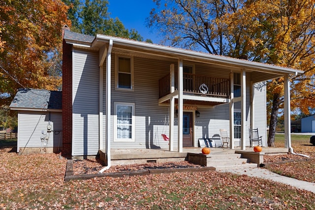 view of front of house with a patio area and a balcony