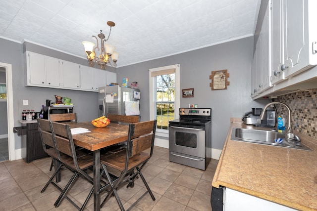 kitchen with hanging light fixtures, stainless steel appliances, crown molding, sink, and white cabinetry