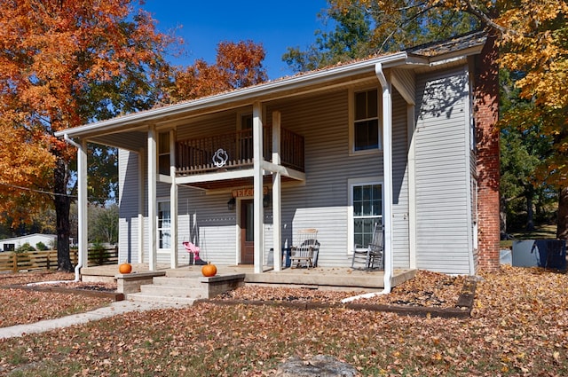 view of front facade featuring a patio and a balcony