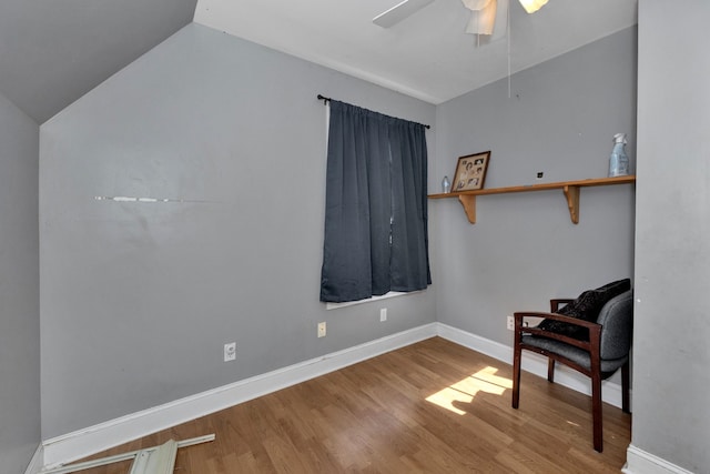 sitting room featuring hardwood / wood-style floors, vaulted ceiling, and ceiling fan