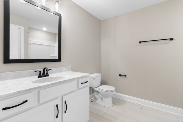 full bathroom featuring toilet, vanity, baseboards, a shower, and tile patterned floors