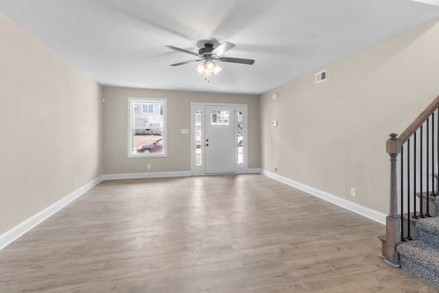 foyer with ceiling fan and light hardwood / wood-style flooring