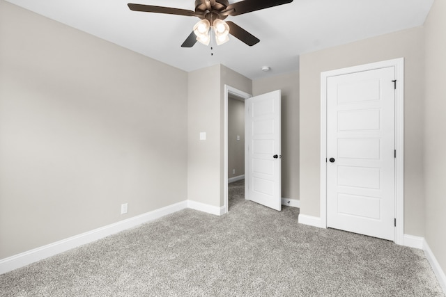 unfurnished bedroom with ceiling fan, carpet flooring, and baseboards