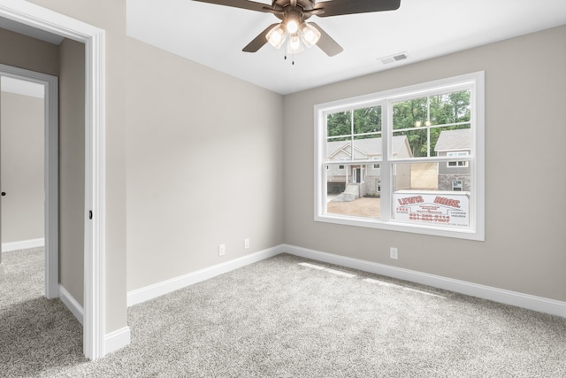 unfurnished room featuring baseboards, visible vents, and carpet flooring