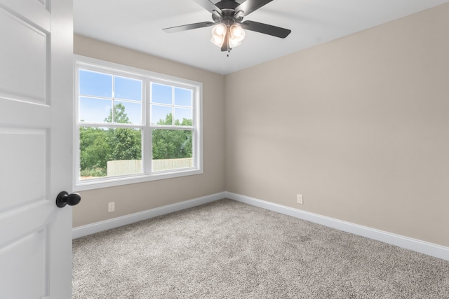 empty room featuring carpet floors, baseboards, and a ceiling fan