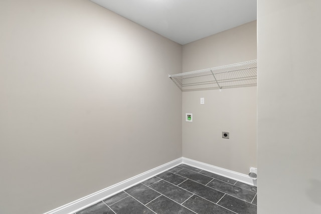 washroom with hookup for a washing machine, hookup for an electric dryer, laundry area, dark tile patterned floors, and baseboards