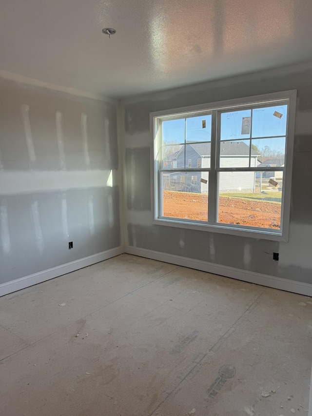 spare room with a textured ceiling